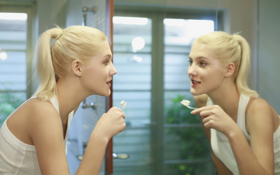 young girl brushing her teeth